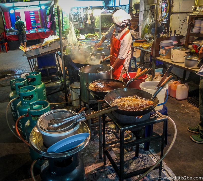 Woman cooking with traditional cooking utensils in Chiang Mai