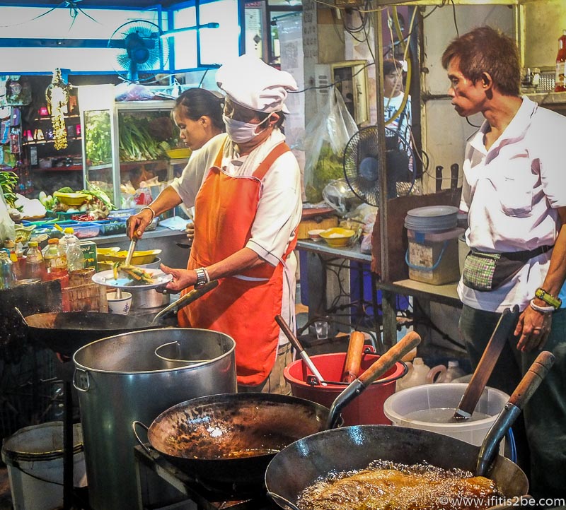 Woman cooking with traditional cooking utensils in Chiang Mai